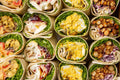 Grid of various wraps with different fillings on a neutral background